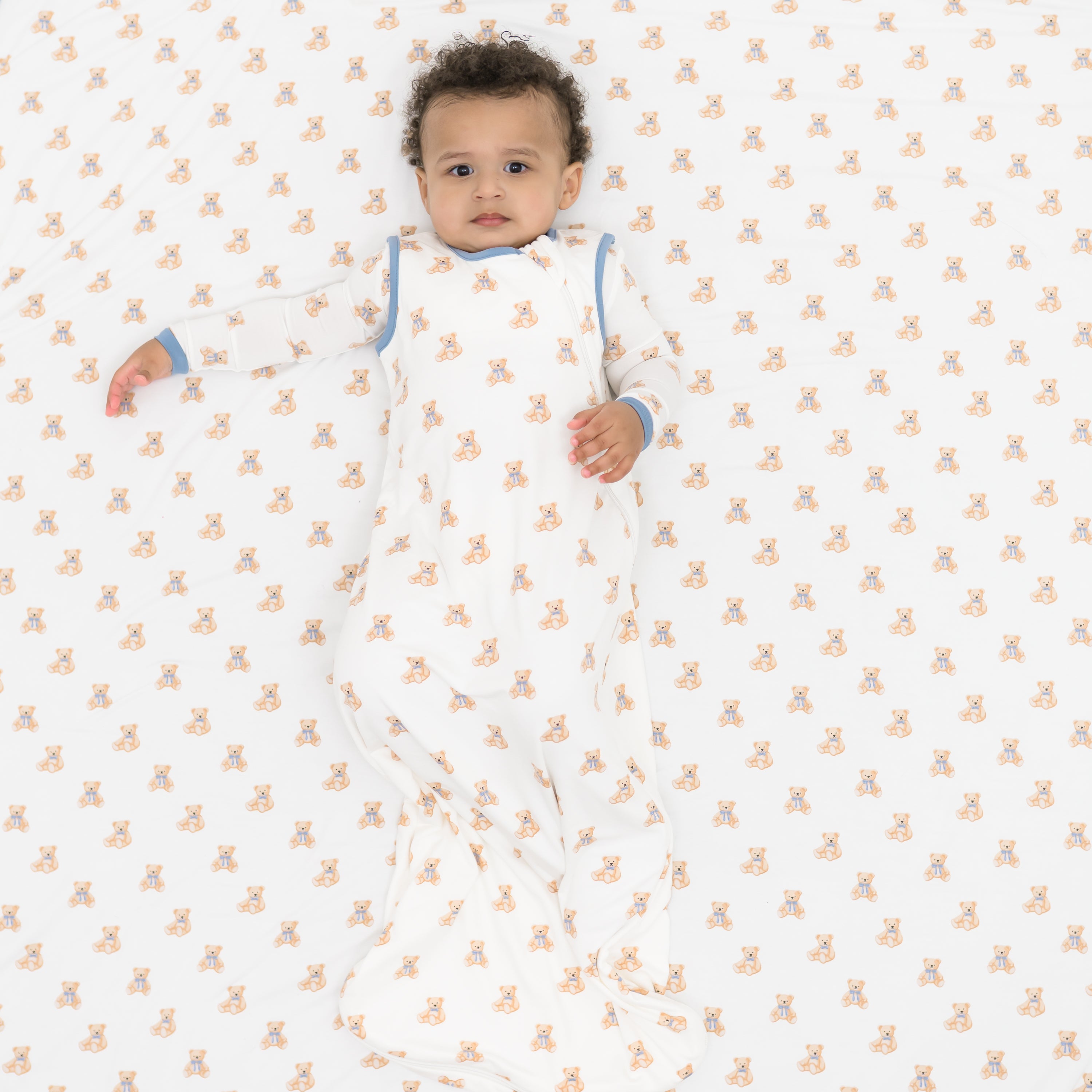 Baby wearing Sleep Bag in Teddy Bear 0.5 laying on a Teddy Bear blanket