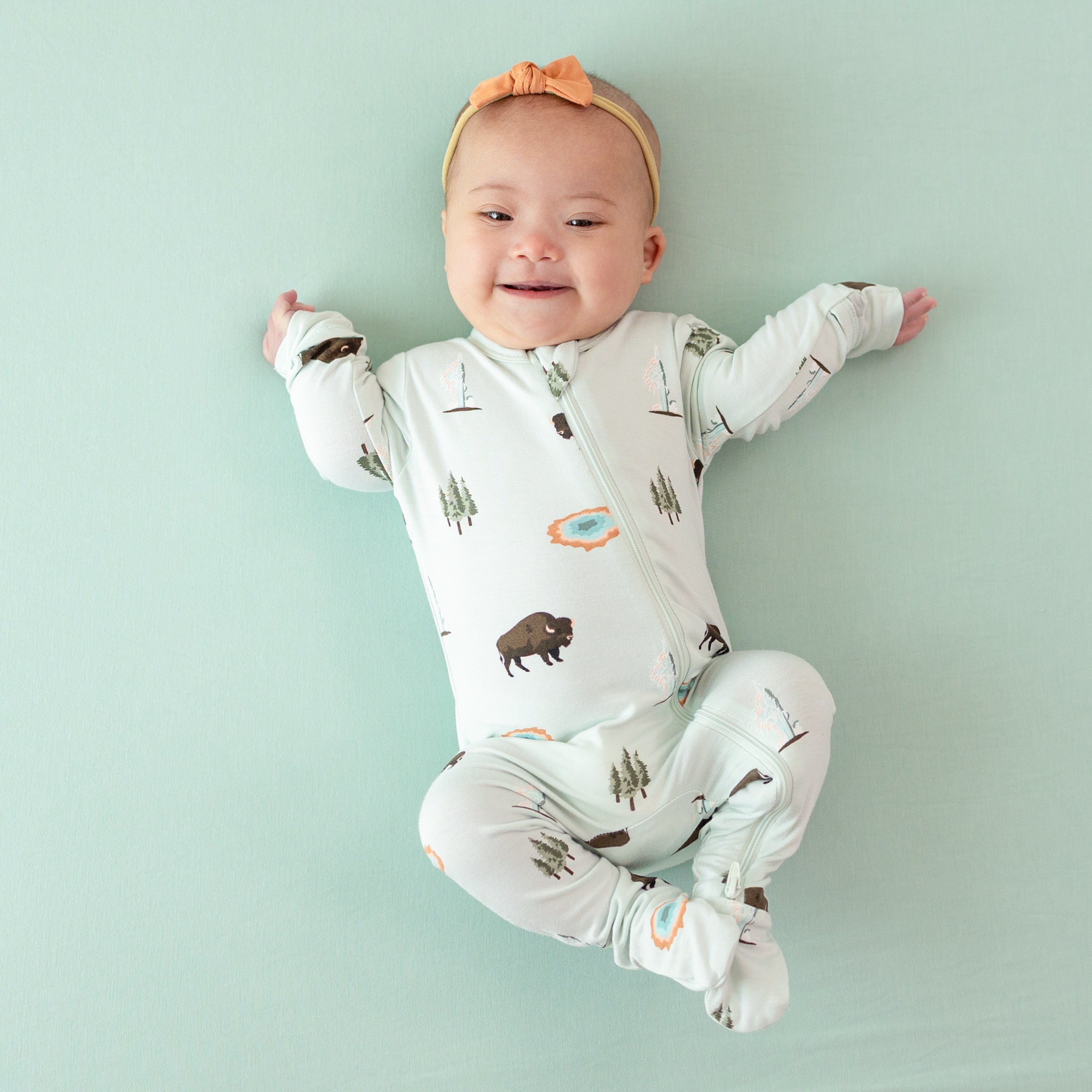 Baby modeling Zippered Footie in Yellowstone 